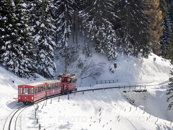 Winter landscape, Schafberg cog railway decorated for Christmas travelling up to the Schafbergalm,