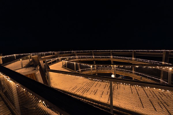 View over a round viewing platform illuminated at night, enchanting forest dwellers, Bad Wildbad