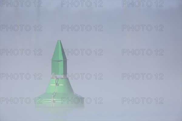 Foggy mood in the morning on the river Peene, fairway buoy in the fog, Flusslandschaft Peenetal