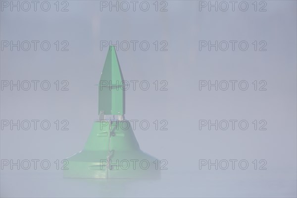 Foggy mood in the morning on the river Peene, fairway buoy in the fog, Flusslandschaft Peenetal