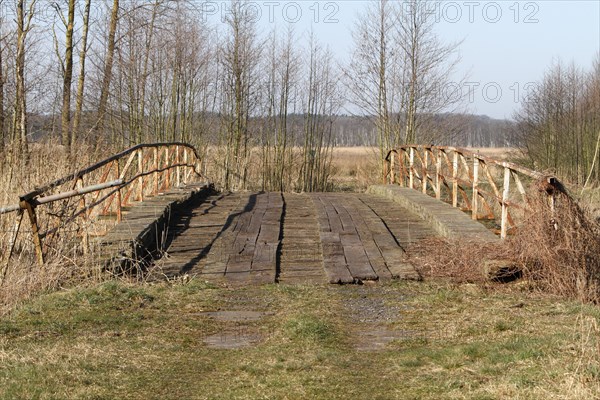 Dilapidated infrastructure on the River Trebel, old dilapidated bridge over the River Trebel,