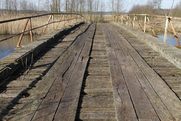 Dilapidated infrastructure on the River Trebel, old dilapidated bridge over the River Trebel,