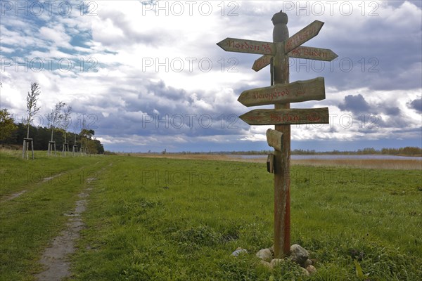 Tourist infrastructure, signpost with writing and runes in the style of the Vikings,