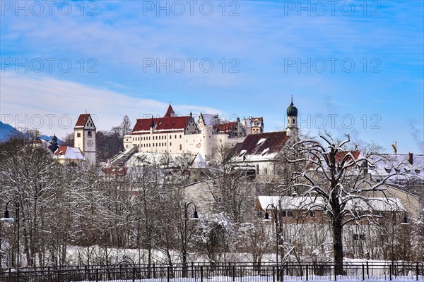 The Gothic High Castle of the Bishops of Augsburg in Füssen in winter, on the right the church of