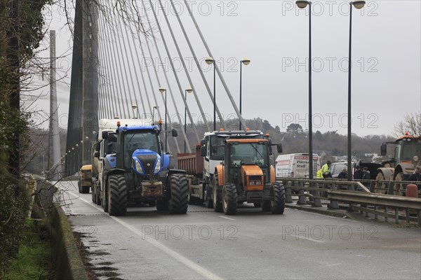 Farmers with tractors, craftsmen with vans and lorry drivers block the closed bridge Pont de