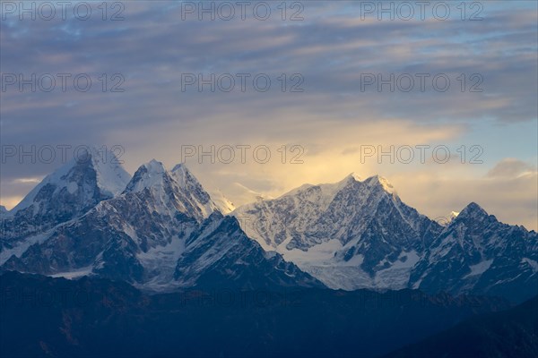 Langtang Himal, under the fairly cloudy sky, lit by the early-morning light, seen at sunrise on a