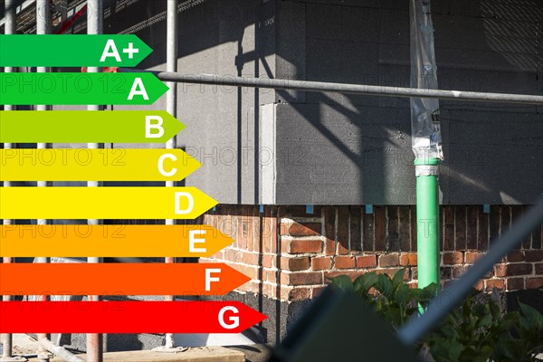 Insulation of a brick house facade with Polystorol insulation boards, graphic with energy