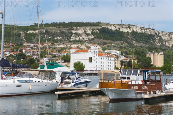 A view of the harbour with various boats and a coastal town, Balchik, Bal?ik, Dobrich, Black Sea,
