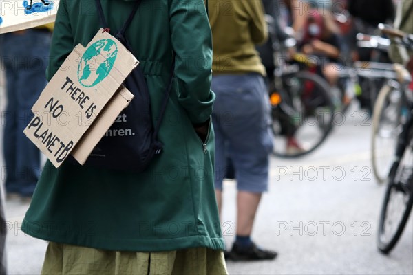 Demonstrator with sign saying There is no planet B at the alliance demo on climate racism and