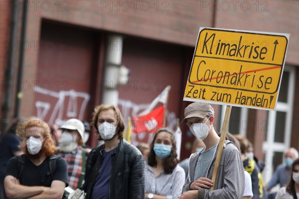 Demonstrators with a sign saying Climate Crisis at the alliance demo on climate racism and climate