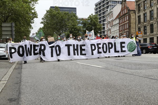 Demonstrators hold a banner with the inscription Power to the people at the alliance demo on