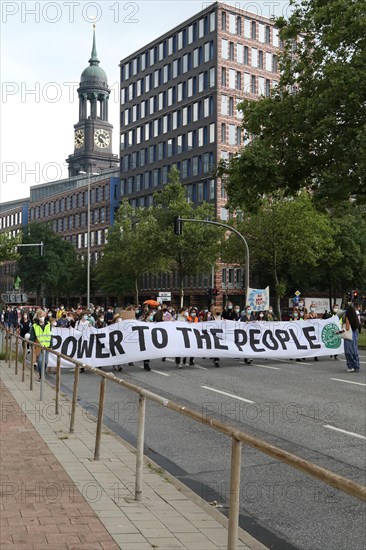 Demonstrators hold a banner with the inscription Power to the people at the alliance demo on