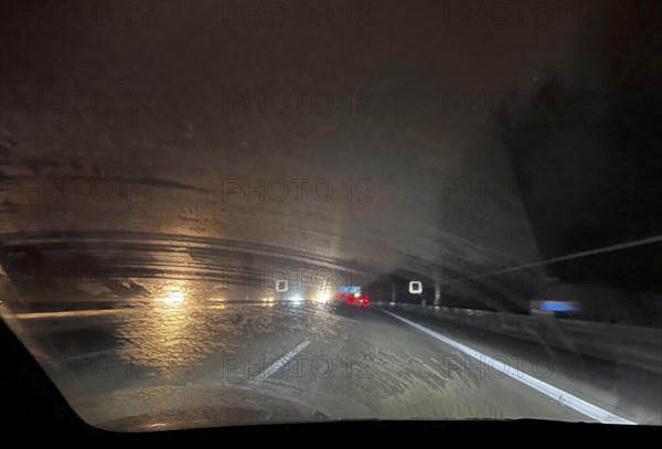 A dirty windscreen and old windscreen wipers obstruct visibility on the motorway