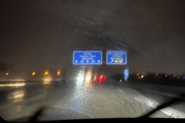 A dirty windscreen and old windscreen wipers obstruct visibility on the motorway