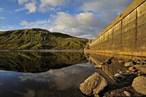 Hydro-electric dam and reservoir in Glen Lyon with pebbled shore and distant ridgeline, Glen Lyon,