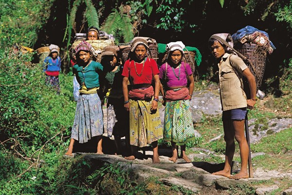 Group of youngsters on a trading trip carrying goods back to their home village in the Makalu