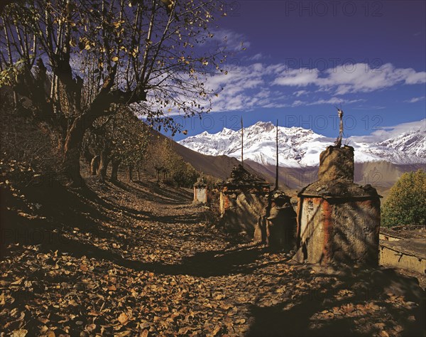 Row of ancient Buddhist devotional objects or chortens with the northern part of the Dhaulagiri