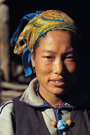 Portrait of pretty Bhotia girl with headscarf at the village of Chhinga in the Mustang region of