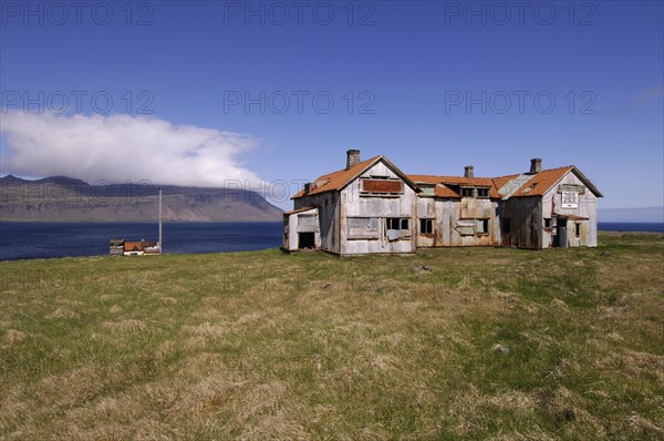 Old abandoned hospital building at the mouth of Faskrudfjordur in the East Fjords region of eastern
