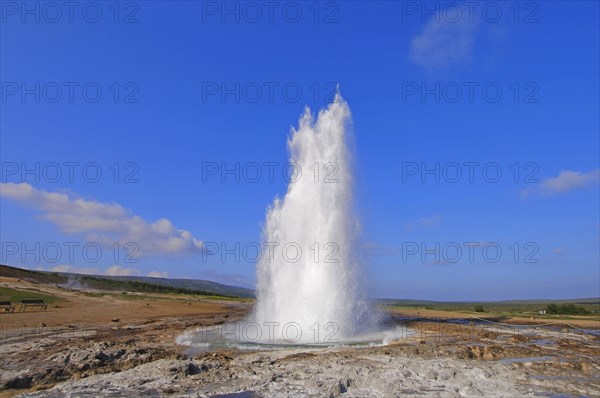 The geyser Strokkur fires steam and boiling water up to a height of around 20m, at Storr Geysir,