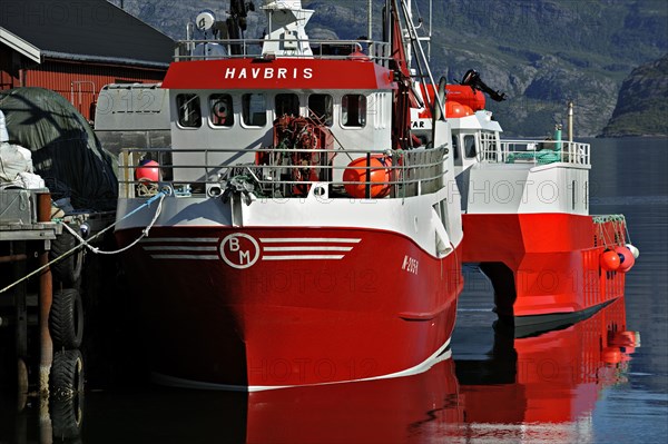 Red boats tied up in harbour at Kilboghamn on Sorfjord, north-west Norway