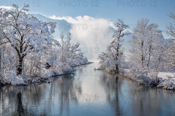 Winter landscape with outflow of the Loisach from the Lake Kochel in front of the Herzogstand