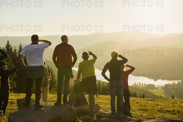 Hiking group, view from Hochfirst to Titisee and Feldberg, sunset, near Neustadt, Black Forest,