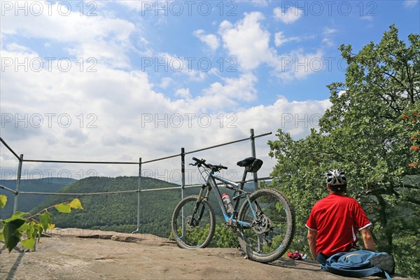 Mountain biker enjoys the view of the Palatinate Forest above Neustadt an der Weinstrasse