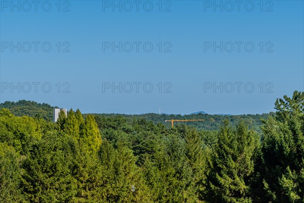 Communication tower, construction crane, concrete block structure and streetlight visible above