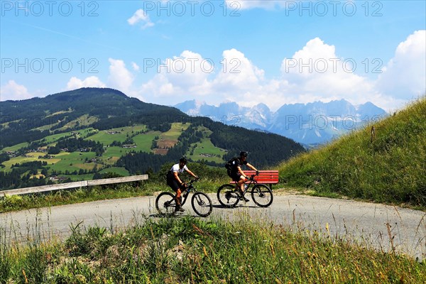 Mountain bikers in the Kitzbuehel Alps with alternating views of the Wilder Kaiser and the