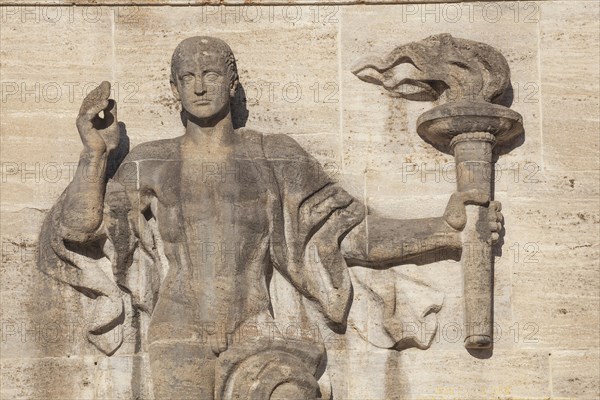 Bearer of the Olympic flame at the entrance portal, Olympic Stadium, 1936 venue of the Winter