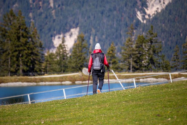 Woman hiking at the Kaltwassersee lake in Seefeld, Tyrol