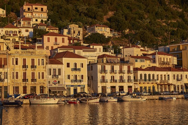 The harbour with sailing boats shines in the golden light of the sunset, Gythio, Mani, Peloponnese,