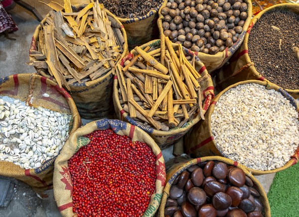 A bird's-eye view of sacks with various colorful spices and herbs for sale at a market in Fort