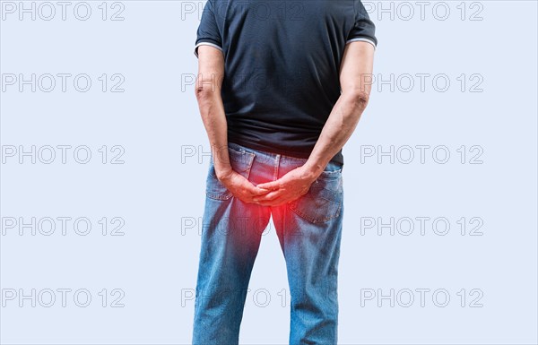 Person with hemorrhoid problem isolated. Elderly people with digestive problem touching his