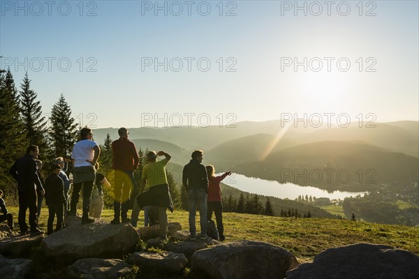Hiking group, view from Hochfirst to Titisee and Feldberg, sunset, near Neustadt, Black Forest,