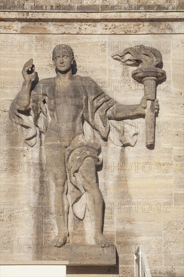 Bearer of the Olympic flame at the entrance portal, Olympic Stadium, 1936 venue of the Winter