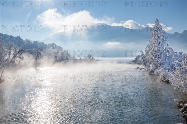 Winter landscape with outflow of the Loisach from the Lake Kochel in front of the Herzogstand