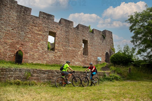 Mountain bikers take a break at the Wolfsburg above Neustadt in the Palatinate Forest, Germany,