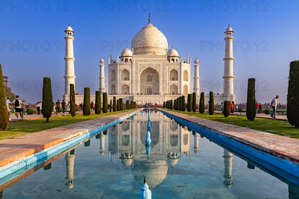 The sublime Taj Mahal is reflected in a long pool of water under a blue sky, Taj Mahal, Agra,