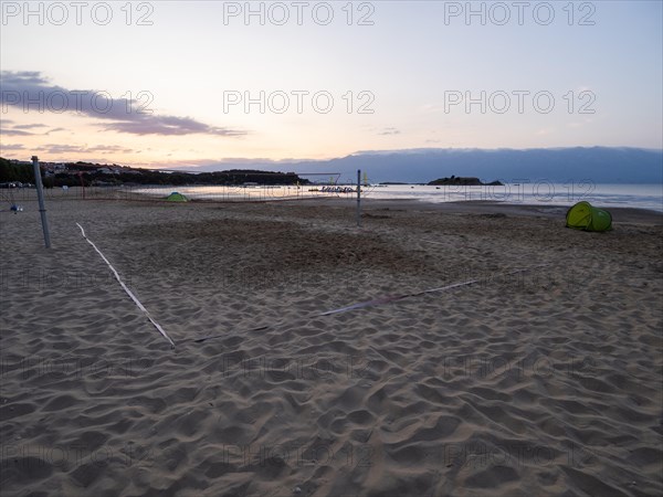 Morning atmosphere on the beach at sunrise, beach volleyball court, Lopar, island of Rab, Kvarner