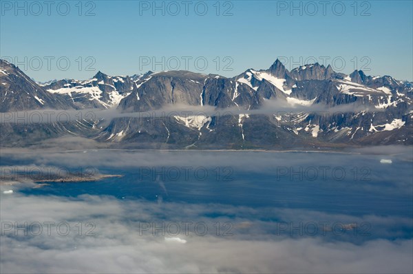 Iceberg, ice and islands, in a fjord, aerial view, rough, snow-covered rough, snow-covered mountain