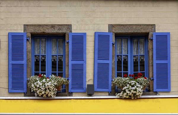 House facade with two windows, blue window frames and blue shutters, Roscoff, Bretagne, France,