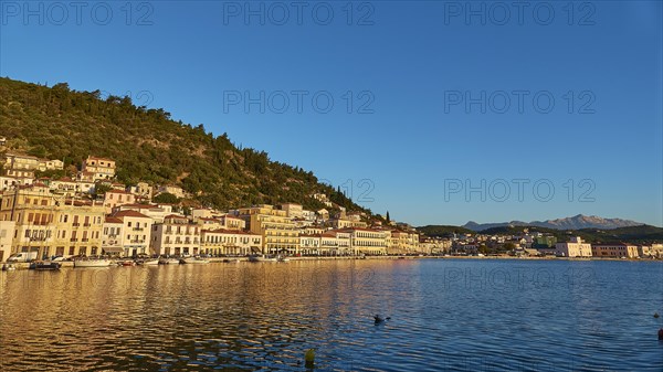 The blue hour brings peace to the coastal landscape and is reflected in the calm sea, Taygetos