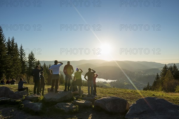 Hiking group, view from Hochfirst to Titisee and Feldberg, sunset, near Neustadt, Black Forest,
