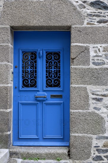 Natural stone house facade with a blue entrance door, Morlaix, Departements Finistere, Brittany,
