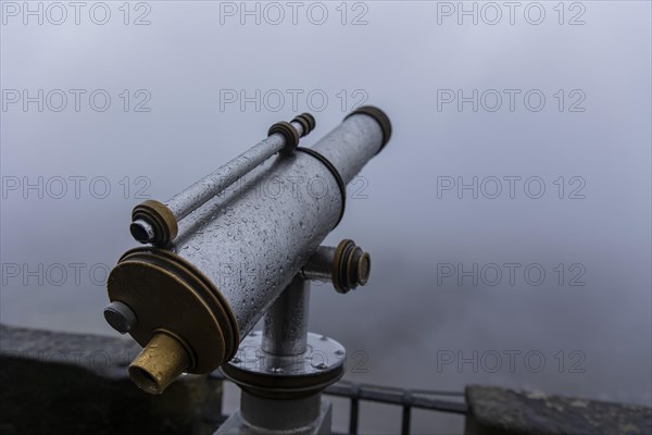 Winter atmosphere at the mountain fortress. Paying telescope with water drops, Koenigstein, Saxony,