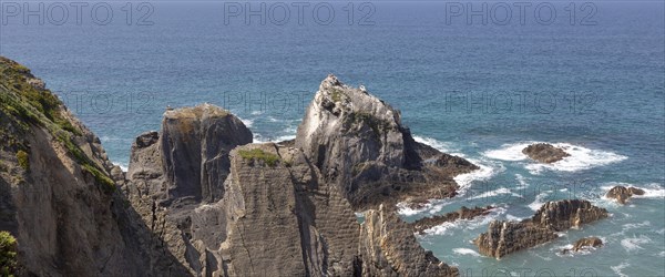 Rocky rugged coastline near Azenha do Mar, Alentejo Littoral, Portugal, southern Europe with white