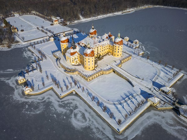 Moritzburg Castle on the castle island surrounded by the frozen castle pond, Moritzburg, Saxony,