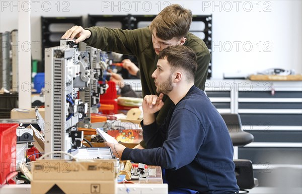 An electronics apprentice assembles a motor protection relay at a Deutsche Bahn training centre,